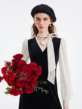 A lady wears a lace patchwork velour dress.